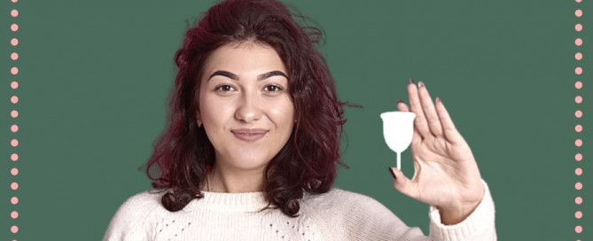 girl holding menstrual cup